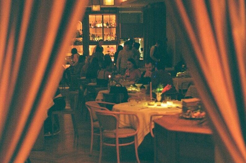 a group of people sitting at a table in a restaurant